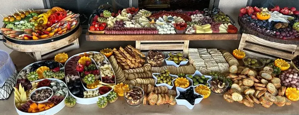 An extravagent charcuterie display with a 60 shape filled with treats