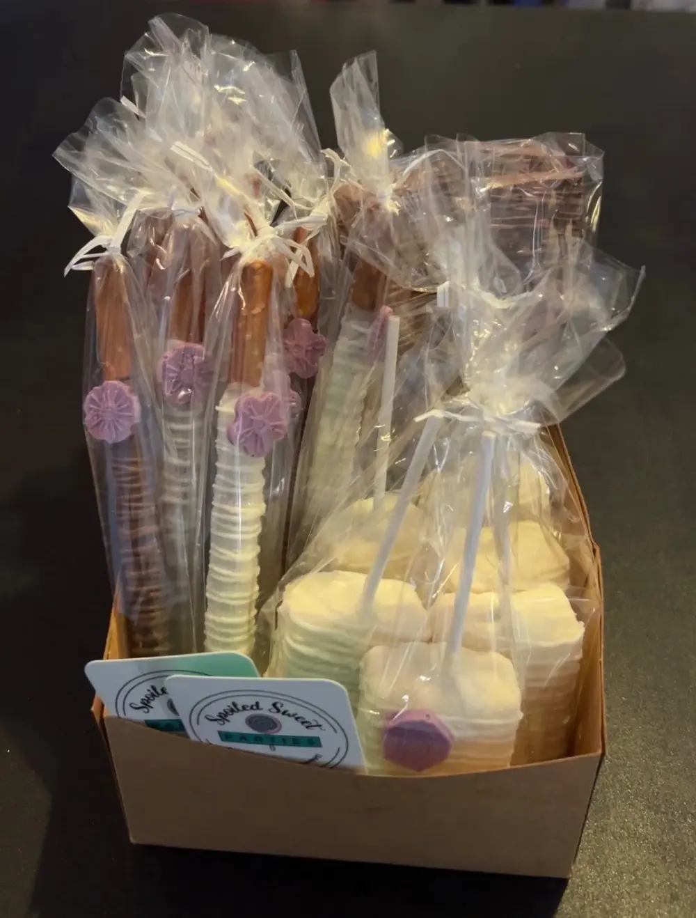 Candy Treats for a party to go artfully arranged and indvidually wrapped in cellophane in a basket
